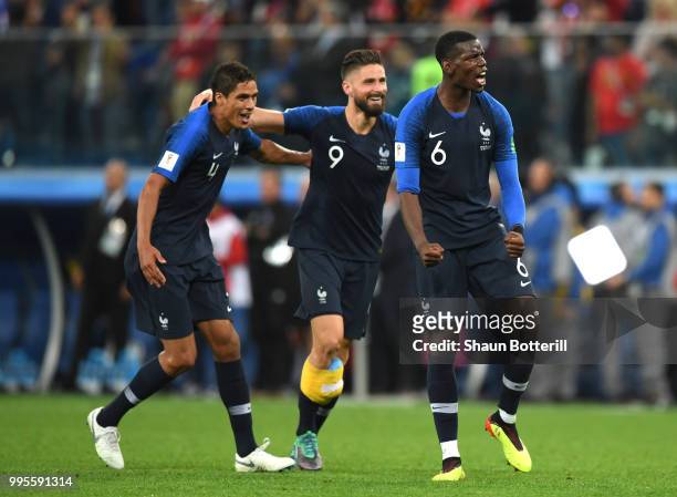 Paul Pogba, Raphael Varane and Olivier Giroud of France celebrate victory following the 2018 FIFA World Cup Russia Semi Final match between Belgium...