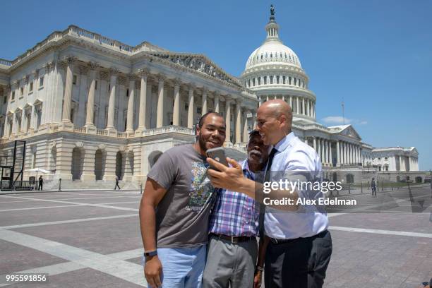 Senator Cory Booker takes a selfie with tourists outside the U.S. Capitol on July 10, 2018 in Washington, DC. U.S. President Donald Trump nominated...