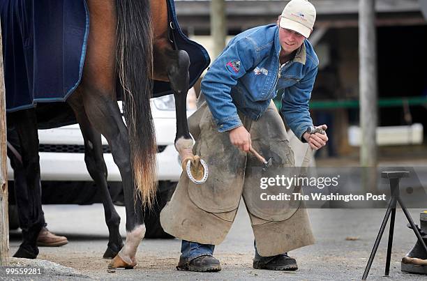 Farrirer, Casey Smith shoes race horses as horse breeders and owners get ready for a horse sale following this weekend's Preakness at the Maryland...