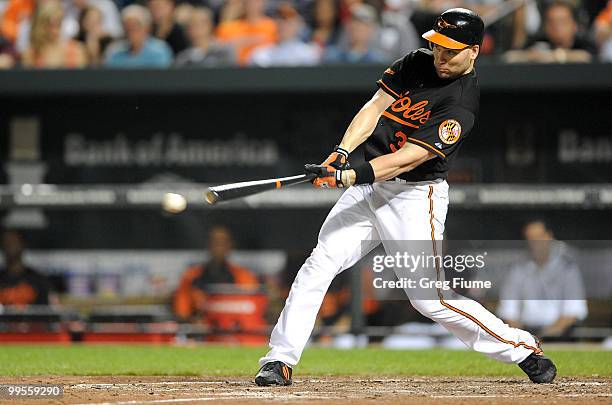 Luke Scott of the Baltimore Orioles hits a single in the third inning against the Cleveland Indians at Camden Yards on May 14, 2010 in Baltimore,...