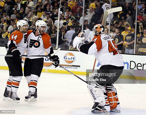 Kimmo Timonen and Mike Richards of the Philadelphia Flyers celebrates the win with goalie Michael Leighton after defeated the Boston Bruins in Game...