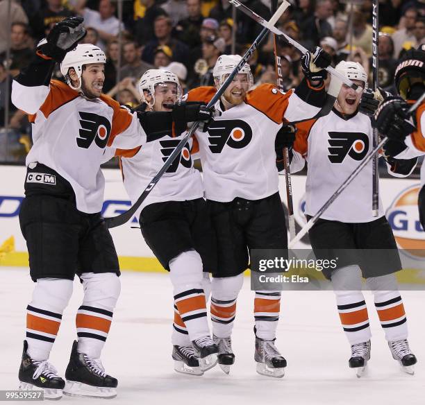 Daniel Carcillo, Danny Briere, Claude Giroux and Matt Carle of the Philadelphia Flyers celebrate the win over the Boston Bruins in Game Seven of the...