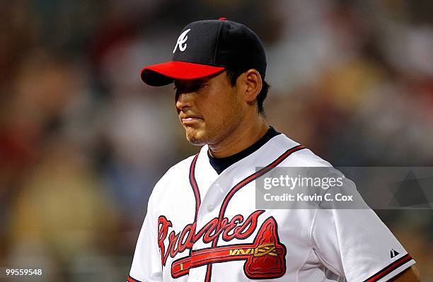 Starting pitcher Kenshin Kawakami of the Atlanta Braves walks to the dugout after getting pulled against the Arizona Diamondbacks at Turner Field on...