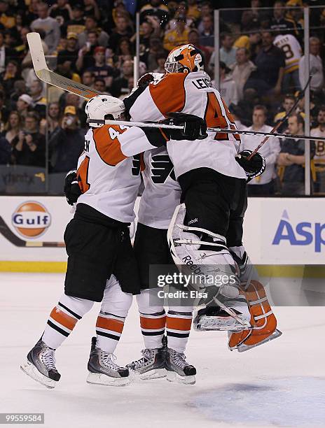 Kimmo Timonen and Mike Richards of the Philadelphia Flyers celebrates the win with goalie Michael Leighton after defeated the Boston Bruins in Game...