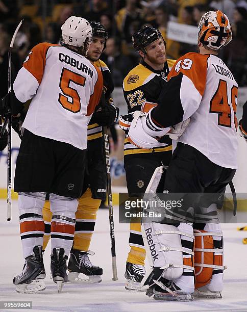Shawn Thornton and Milan Lucic of the Boston Bruins congratulate Braydon Coburn and Michael Leighton of the Philadelphia Flyers in Game Seven of the...
