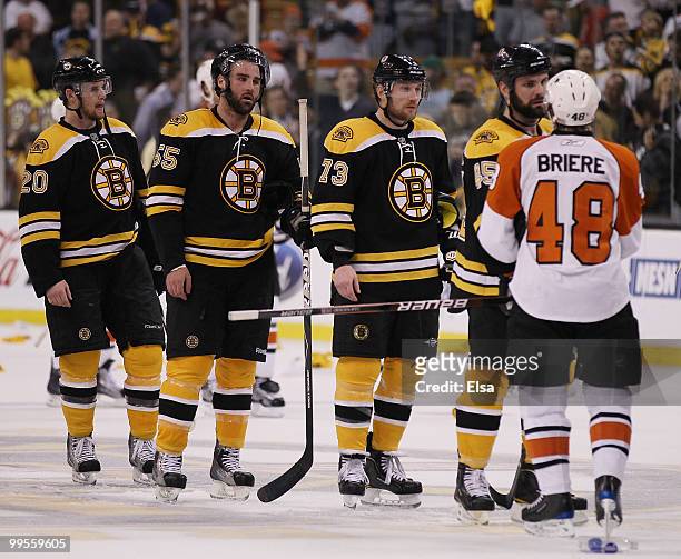 Mark Stuart, Michael Ryder, Johnny Boychuk and Daniel Paille of the Boston Bruins congratulate Danny Briere of the Philadelphia Flyers in Game Seven...