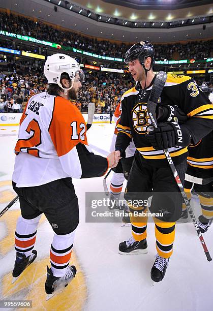 Zdeno Chara of the Boston Bruins shakes hands with Simon Gagne of the Philadelphia Flyers after Game Seven of the Eastern Conference Semifinals...