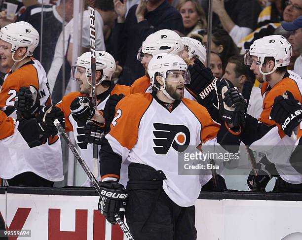 Simon Gagne of the Philadelphia Flyers is congratulated by teammates on the bench after he scored the game winning goal in the third period against...