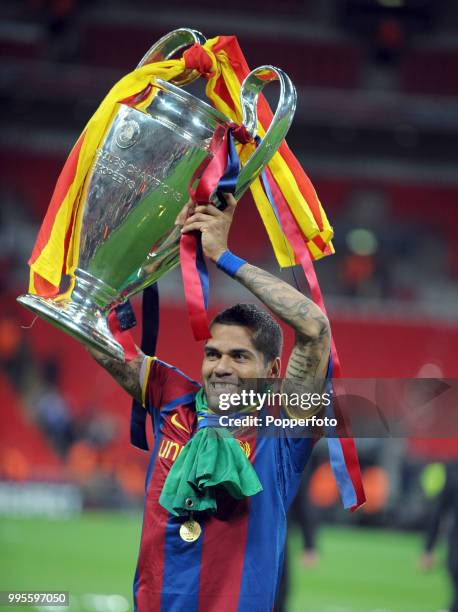 Daniel Alves of FC Barcelona holds aloft the European Cup following the UEFA Champions League final between FC Barcelona and Manchester United at...