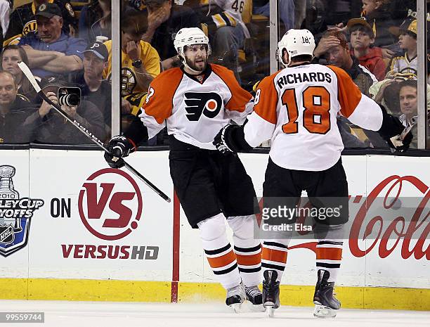 Simon Gagne of the Philadelphia Flyers is congratulated by teammate Mike Richards after Gagne scored the game winner on a power play in the third...