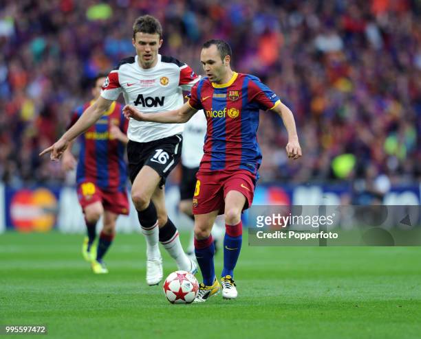 Andres Iniesta of FC Barcelona and Michael Carrick of Manchester United in action during the UEFA Champions League final between FC Barcelona and...