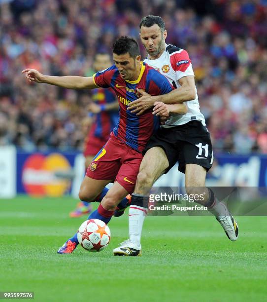 David Villa of FC Barcelona is challenged by Ryan Giggs of Manchester United during the UEFA Champions League final between FC Barcelona and...