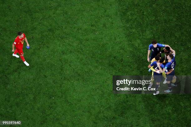 Eden Hazard of Belgium looks dejected as the France players celebrate following their sides victory in the 2018 FIFA World Cup Russia Semi Final...