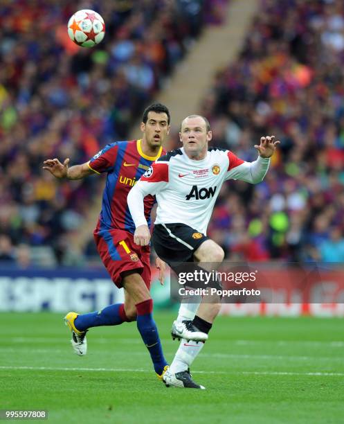 Sergio Busquets of FC Barcelona moves in to challenge Wayne Rooney of Manchester United during the UEFA Champions League final between FC Barcelona...