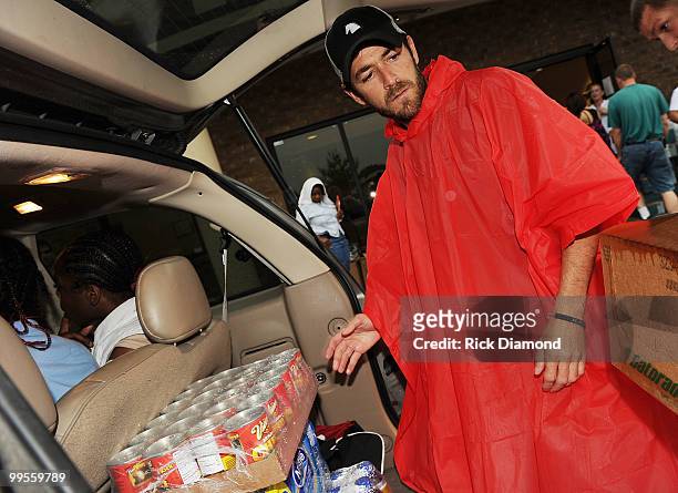 During lightening, hail and flash flood warnings Actor Luke Perry, part time Middle Tennessee resident volunteers with Soles4souls Inc.to bring...