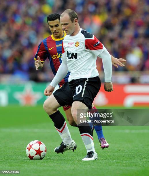 Wayne Rooney of Manchester United with Pedro Rodriguez of FC Barcelona during the UEFA Champions League final between FC Barcelona and Manchester...