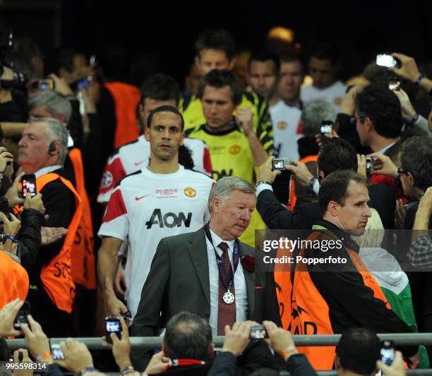 Manchester United manager Sir Alex Ferguson, wearing his runners-up medal , with Rio Ferdinand behind, looking dejeted, after the UEFA Champions...