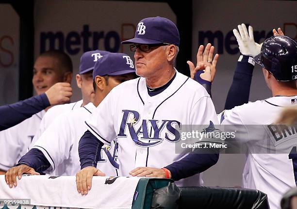 Manager Joe Maddon of the Tampa Bay Rays watches his team from the dugout against the Seattle Mariners during the game at Tropicana Field on May 14,...