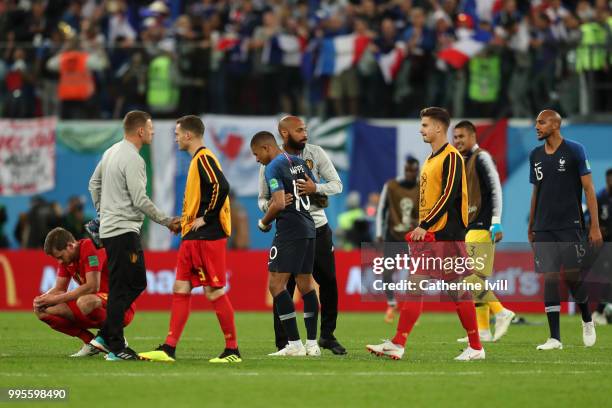 Belgium assistant coach Thierry Henry cheers Kylian Mbappe of France following the 2018 FIFA World Cup Russia Semi Final match between Belgium and...