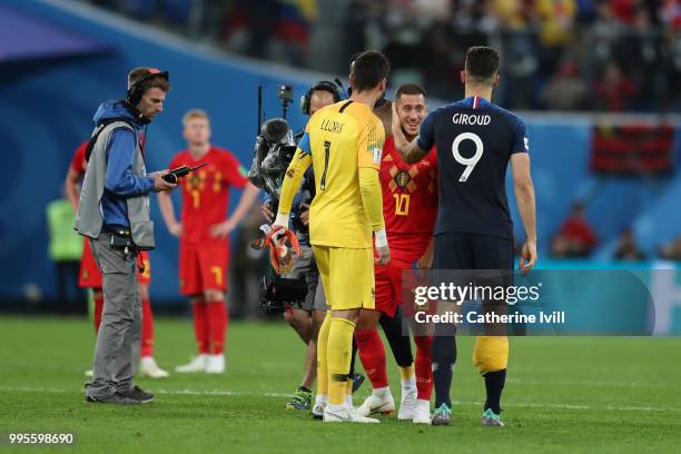 Olivier Giroud of France consoles Eden Hazard of Belgium following Belgium's defeat in the 2018 FIFA World Cup Russia Semi Final match between...