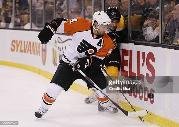 Kimmo Timonen of the Philadelphia Flyers tries to keep the puck from Milan Lucic of the Boston Bruins in Game Seven of the Eastern Conference...