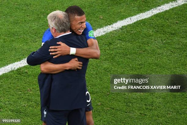 France's forward Kylian Mbappe celebrates with France's coach Didier Deschamps at the end of the Russia 2018 World Cup semi-final football match...