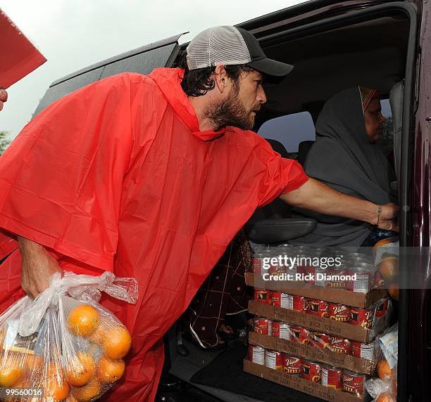 During lightening, hail and flash flood warnings Actor Luke Perry, part time Middle Tennessee resident volunteers with Soles4souls Inc.to bring...