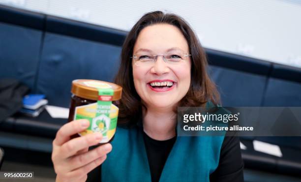 The designated SPD parliamentary group chairwoman Andrea Nahles presents a glas of honey during the start of the SPD parliamentary group meeting at...