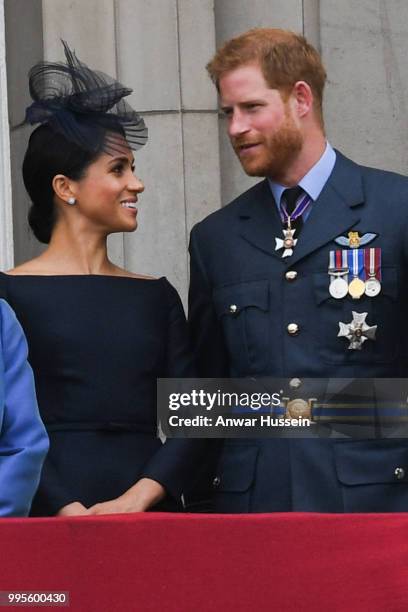 Meghan, Duchess of Sussex, and Prince Harry, Duke of Sussex stand on the balcony of Buckingham Palace to view a flypast to mark the centenary of the...