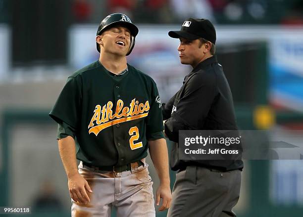 Cliff Pennington of the Oakland Athletics reacts to a call by third base umpire Chris Guccione after he was caught stealing in the first inning...