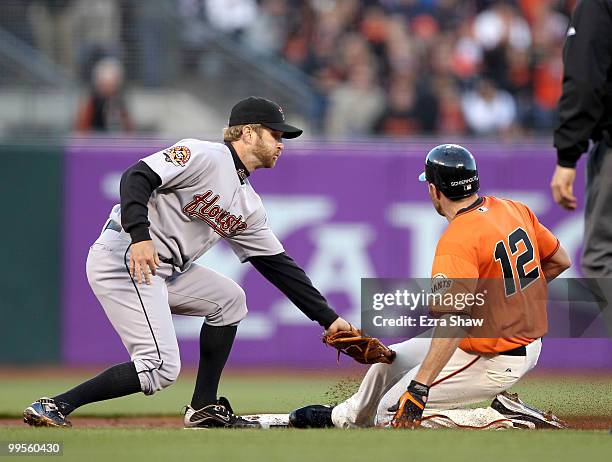 Nate Schierholtz of the San Francisco Giants beats the tag of Jeff Keppinger of the Houston Astros to safely steal second base in the second inning...
