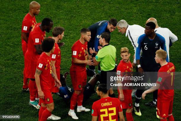 Belgium's forward Eden Hazard argues with Uruguayan referee Andres Cunha during the Russia 2018 World Cup semi-final football match between France...