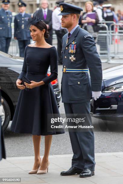 Prince Harry, Duke of Sussex and Meghan, Duchess of Sussex, wearing a dark navy Dior dress and a hat by milliner Stephen Jones, attend a service at...