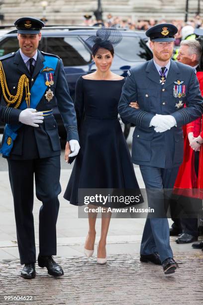 Prince William, Duke of Cambridge, Prince Harry, Duke of Sussex and Meghan, Duchess of Sussex, wearing a dark navy Dior dress and a hat by milliner...