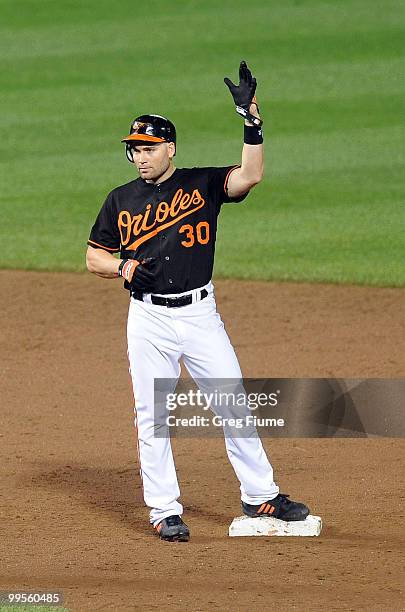 Luke Scott of the Baltimore Orioles celebrates after a hit in the sixth inning against the Cleveland Indians at Camden Yards on May 14, 2010 in...