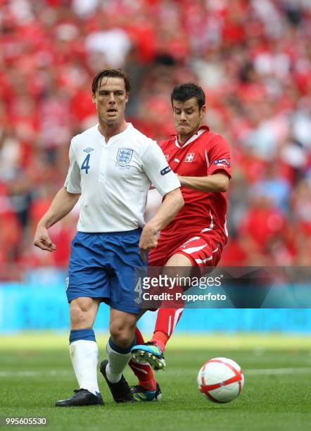 Scott Parker of England and Tranquillo Barnetta of Switzerland in action during the UEFA EURO 2012 group G qualifying match between England and...