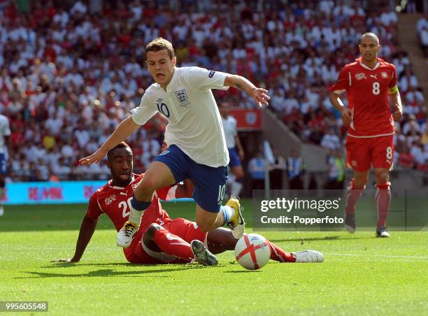 Jack Wilshere of England is fouled by Johan Djourou of Switzerland during the UEFA EURO 2012 group G qualifying match between England and Switzerland...