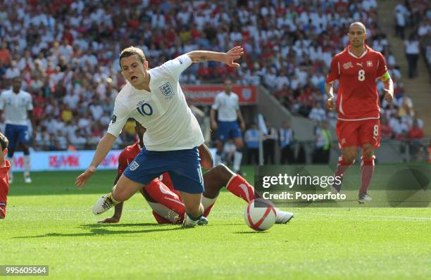 Jack Wilshere of England is fouled by Johan Djourou of Switzerland during the UEFA EURO 2012 group G qualifying match between England and Switzerland...