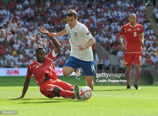 Jack Wilshere of England is fouled by Johan Djourou of Switzerland during the UEFA EURO 2012 group G qualifying match between England and Switzerland...