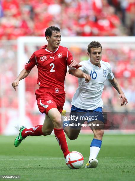 Jack Wilshere of England and Stephan Lichtsteiner of Switzerland in action during the UEFA EURO 2012 group G qualifying match between England and...