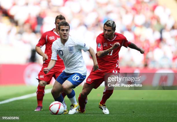 Jack Wilshere of England and Valon Behrami of Switzerland in action during the UEFA EURO 2012 group G qualifying match between England and...