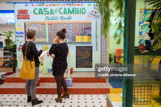 Visitors stand in front of a part of the artwork 'Amazonas Shopping Center' by Sol Calero at the exhibition of the nominees for the prize of the...