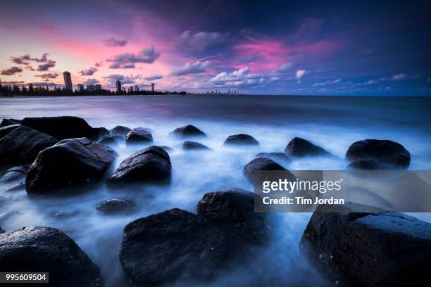 burleigh heads sunset over the rocks - burleigh beach stock pictures, royalty-free photos & images