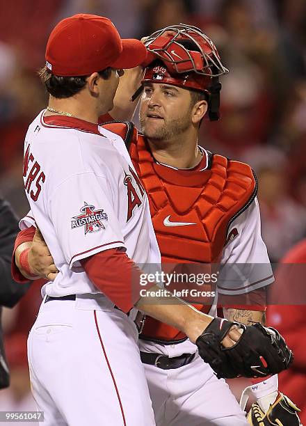 Starting pitcher Joe Saunders of the Los Angeles Angels of Anaheim is congratulated by catcher Mike Napoli after pitching a complete game shutout...