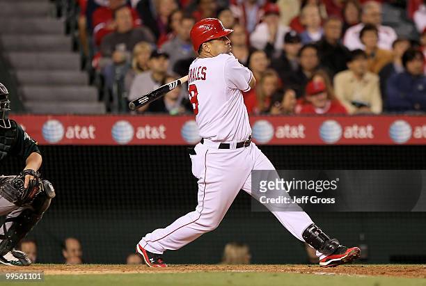 Kendry Morales of the Los Angeles Angels of Anaheim hits an RBI single scoring teammate Erick Aybar in the sixth inning against the Oakland Athletics...