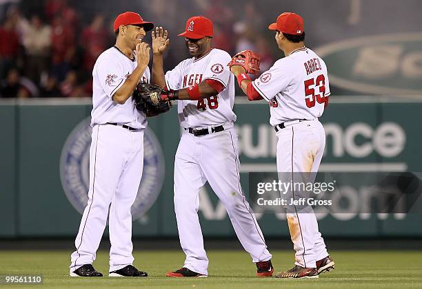 Juan Rivera, Torii Hunter and Bobby Abreu of the Los Angeles Angels of Anaheim celebrate following the game against the Oakland Athletics at Angel...