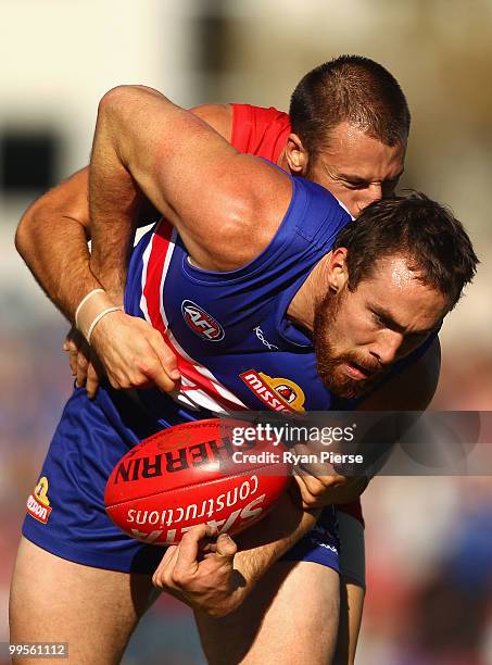 Ben Hudson of the Bulldogs is tackled by Nick Malceski of the Swans during the round eight AFL match between the Western Bulldogs and the Sydney...