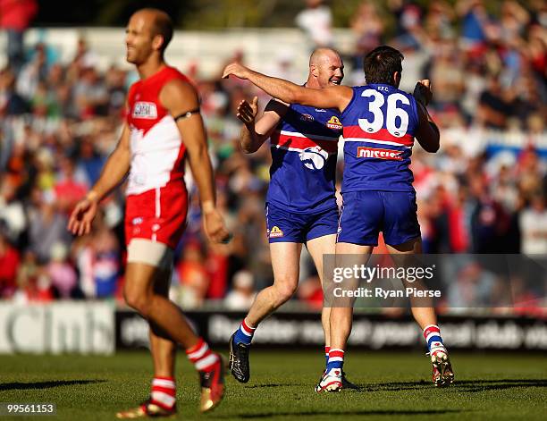 Barry Hall and Brian Lake of the Bulldogs celebrate a goal during the round eight AFL match between the Western Bulldogs and the Sydney Swans at...