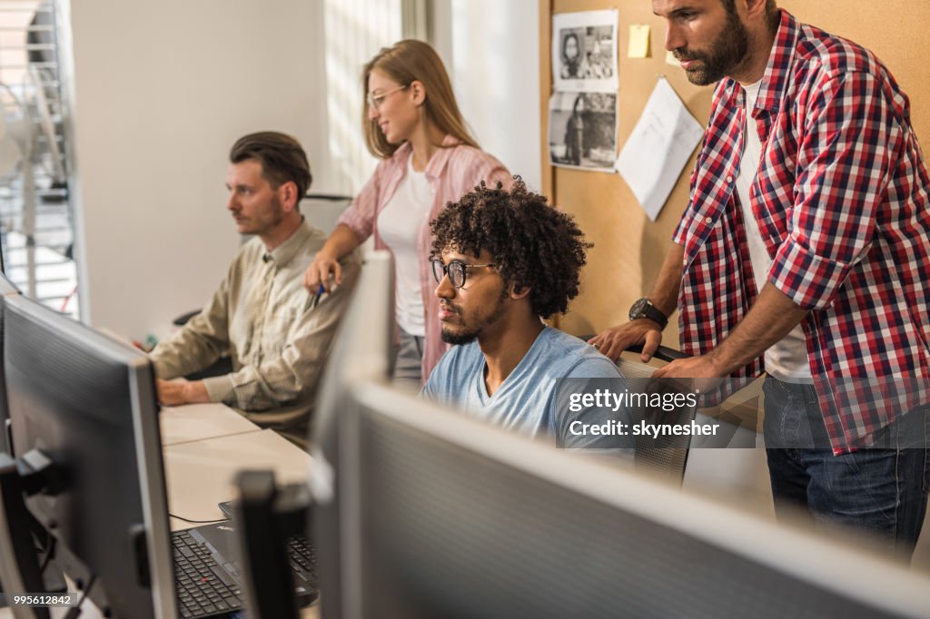 Group Of Computer Programmers Working On Desktop Pc In The Office High ...