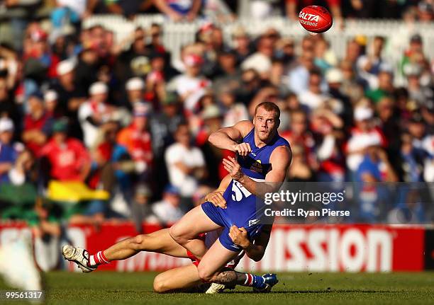 Adam Cooney of the Bulldogs gets a handball away during the round eight AFL match between the Western Bulldogs and the Sydney Swans at Manuka Oval on...